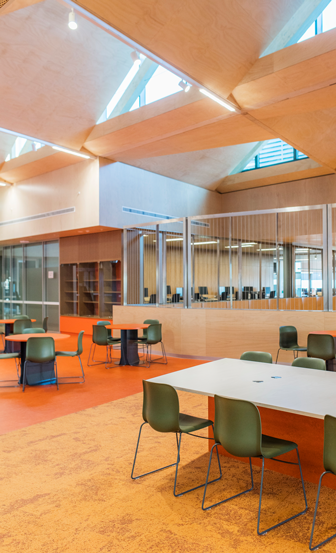 Åbent lokale i skarpe farver med stole og borde